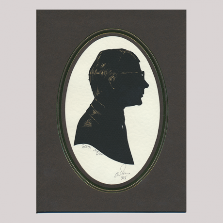 
        Silhouette, with man in frame looking right, wearing glasses.